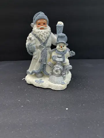 Santa Standing with Buddy on Train